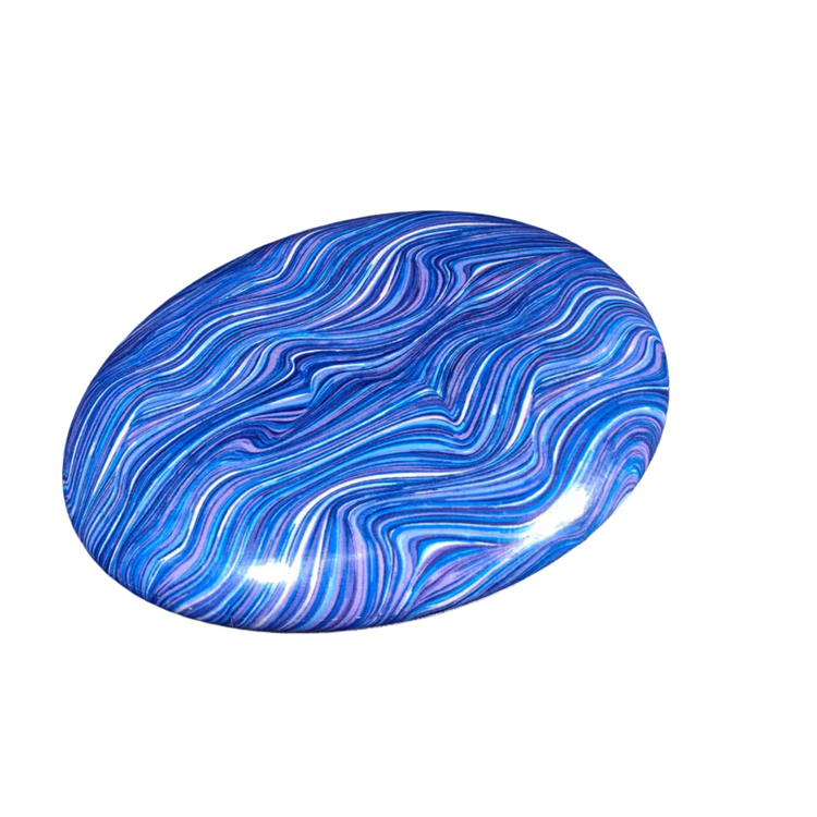 Standalone 230mm flying disc made from recycled Fijian beach waste showing vibrant, one-of-a-kind upcycled colour patterns in waves.