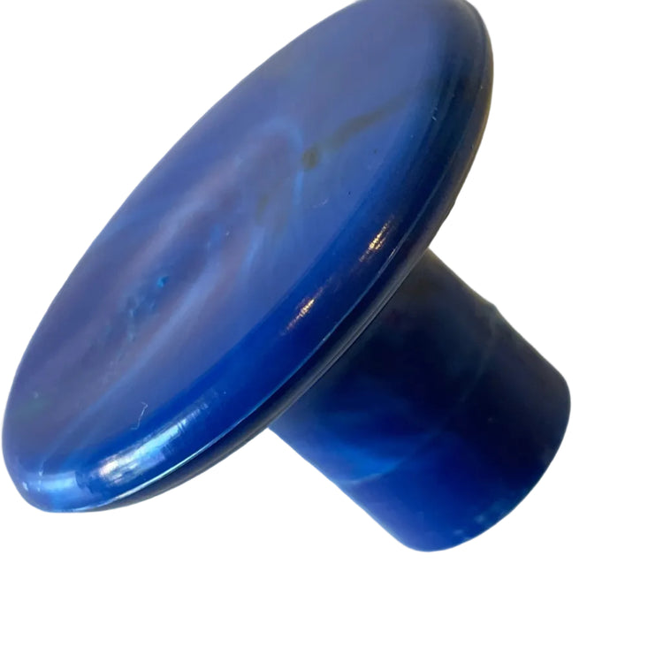 Detailed close-up view of the unique marbled texture on a handmade recycled plastic round wall hook side view.