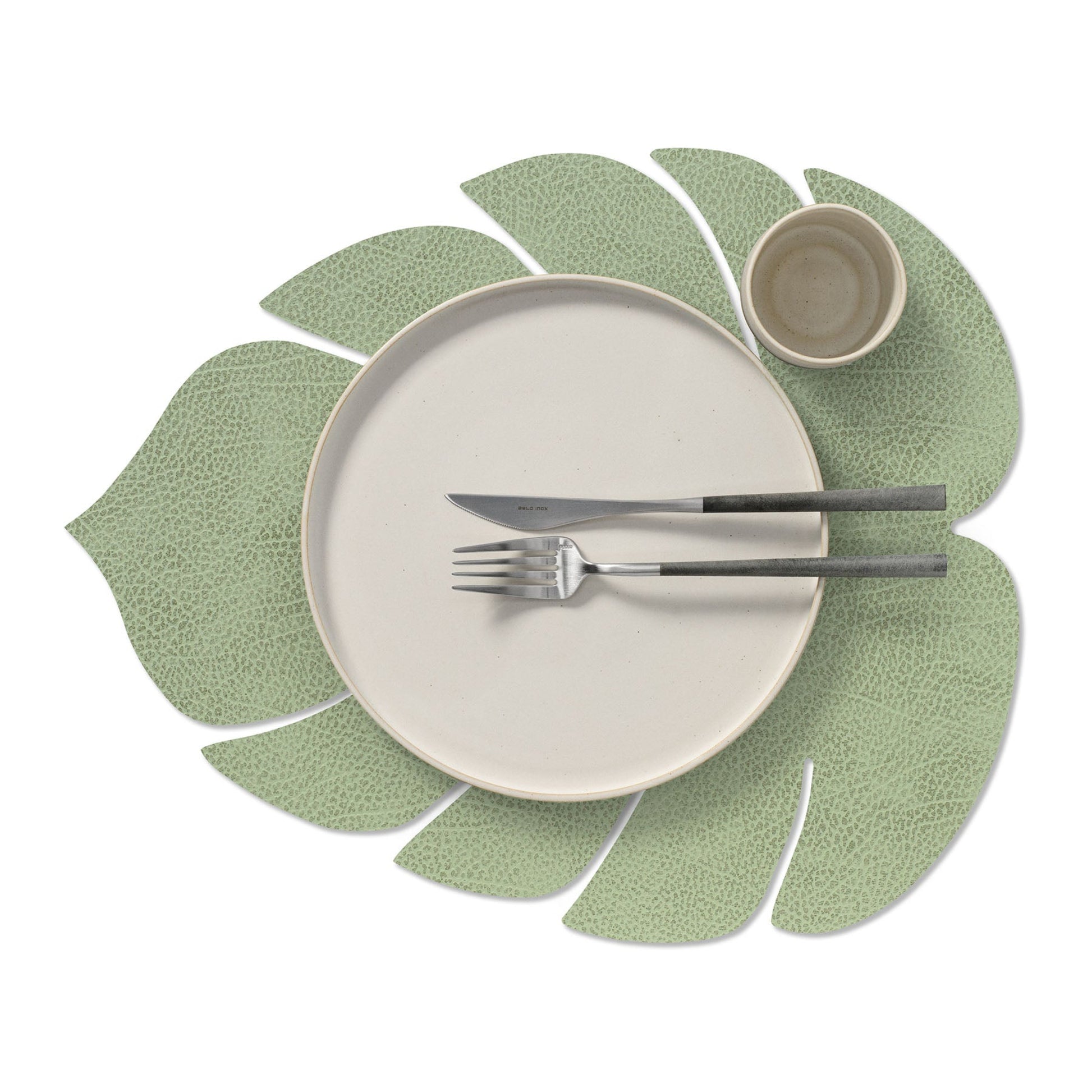 Monstera leaf recycled leather placemat featuring the signature LIND DNA Hippo finish in olive green.