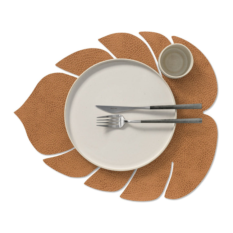 Monstera Leaf recycled leather placemats showing nupo texture, styled with a plate, cup, knife and fork.