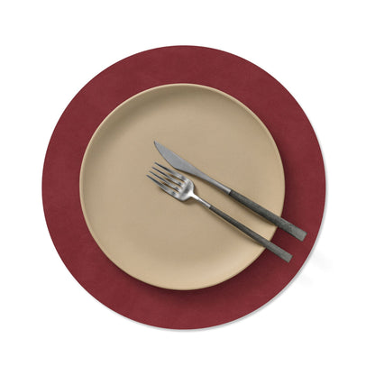 Circle recycled leather placemat featuring the signature LIND DNA Nupo texture with plate setting in red.