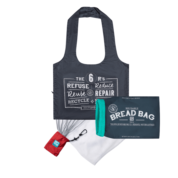 Onya reusable market kit containing a color matched foldable shopping tote bag, an eight pack of mesh produce bags, and a roll top bread bag on a clean white background, available in Australia. charcoal bags and chilli mesh bag holder.