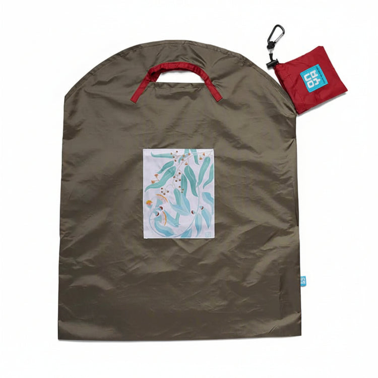 Onya reusable shopping bag with built in shoulder strap and checkout caddy loops next to its attached compact pouch on a clean white background, available in Australia in olive light leaves large variant.