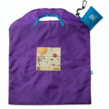 Onya reusable shopping bag with built in shoulder strap and checkout caddy loops next to its attached compact pouch on a clean white background, available in Australia in purple garden large variant.