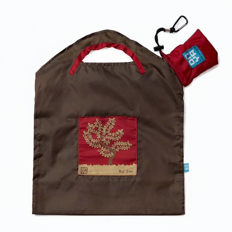 Onya reusable shopping bag with built in shoulder strap and checkout caddy loops next to its attached compact pouch on a clean white background, available in Australia in brown olive tree small variant.