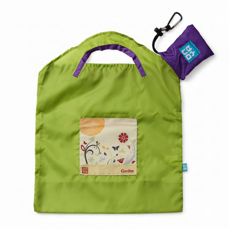 Onya reusable shopping bag with built in shoulder strap and checkout caddy loops next to its attached compact pouch on a clean white background, available in Australia in green apple garden small variant.