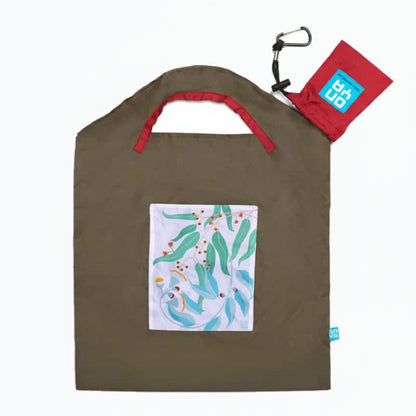 Onya reusable shopping bag with built in shoulder strap and checkout caddy loops next to its attached compact pouch on a clean white background, available in Australia in olive light leaves small variant.