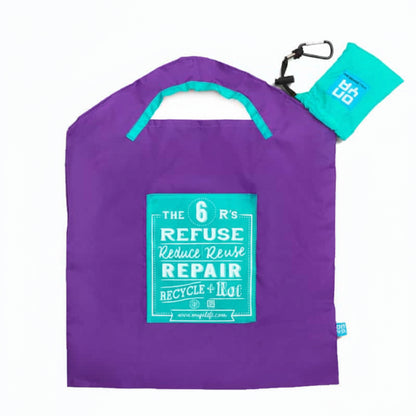 Onya reusable shopping bag with built in shoulder strap and checkout caddy loops next to its attached compact pouch on a clean white background, available in Australia in purple 6R’s small variant.