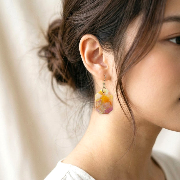 On-model style photo showcasing the fit, drop length, and geometric scale of the upcycled pastel pink and white octagon dangle earrings in Australia.
