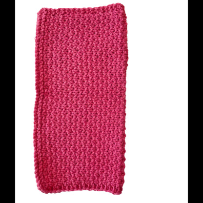 Peonie handmade knitted dishcloth made from absorbent recycled cotton, folded in half, for kitchen and bathroom use on a white background.
