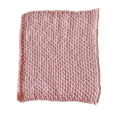 Pink handmade knitted dishcloth made from absorbent recycled cotton for kitchen and bathroom use.