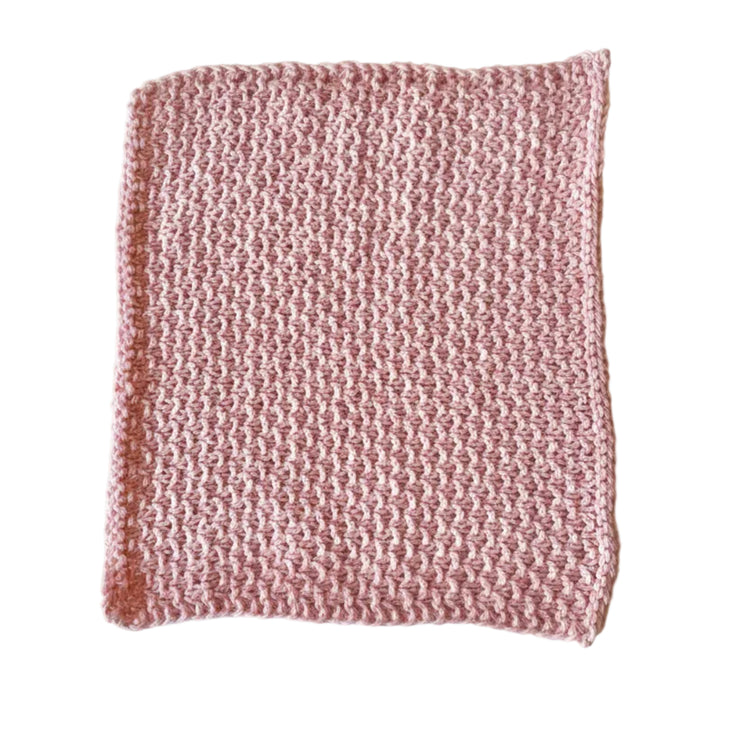 Pink handmade knitted dishcloth made from absorbent recycled cotton for kitchen and bathroom use.