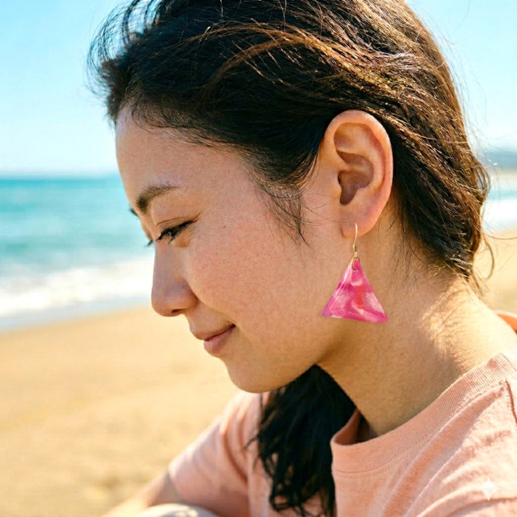 On-model style photo showcasing the drop length, geometric scale, and visual style of the upcycled pink and white triangle dangle earrings in Australia.