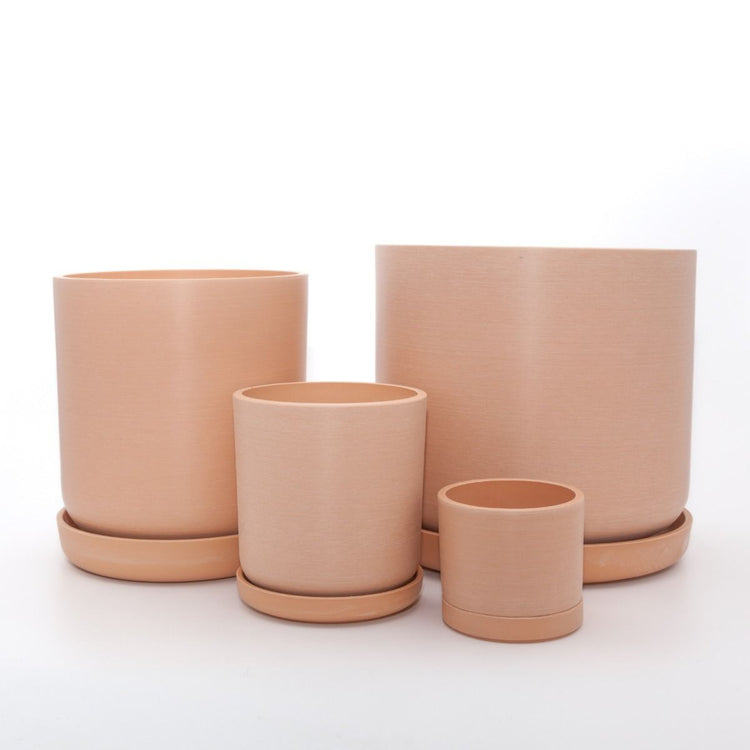 Complete Portland recycled plastic plant pot set of four graduated sizes with matching saucers on a clean white background, available in Australia. Muted coral variant shown.