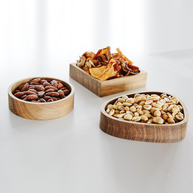 A minimalist LIND DNA oiled oak wood storage box styled on a kitchen dining table as a versatile decor accessory.