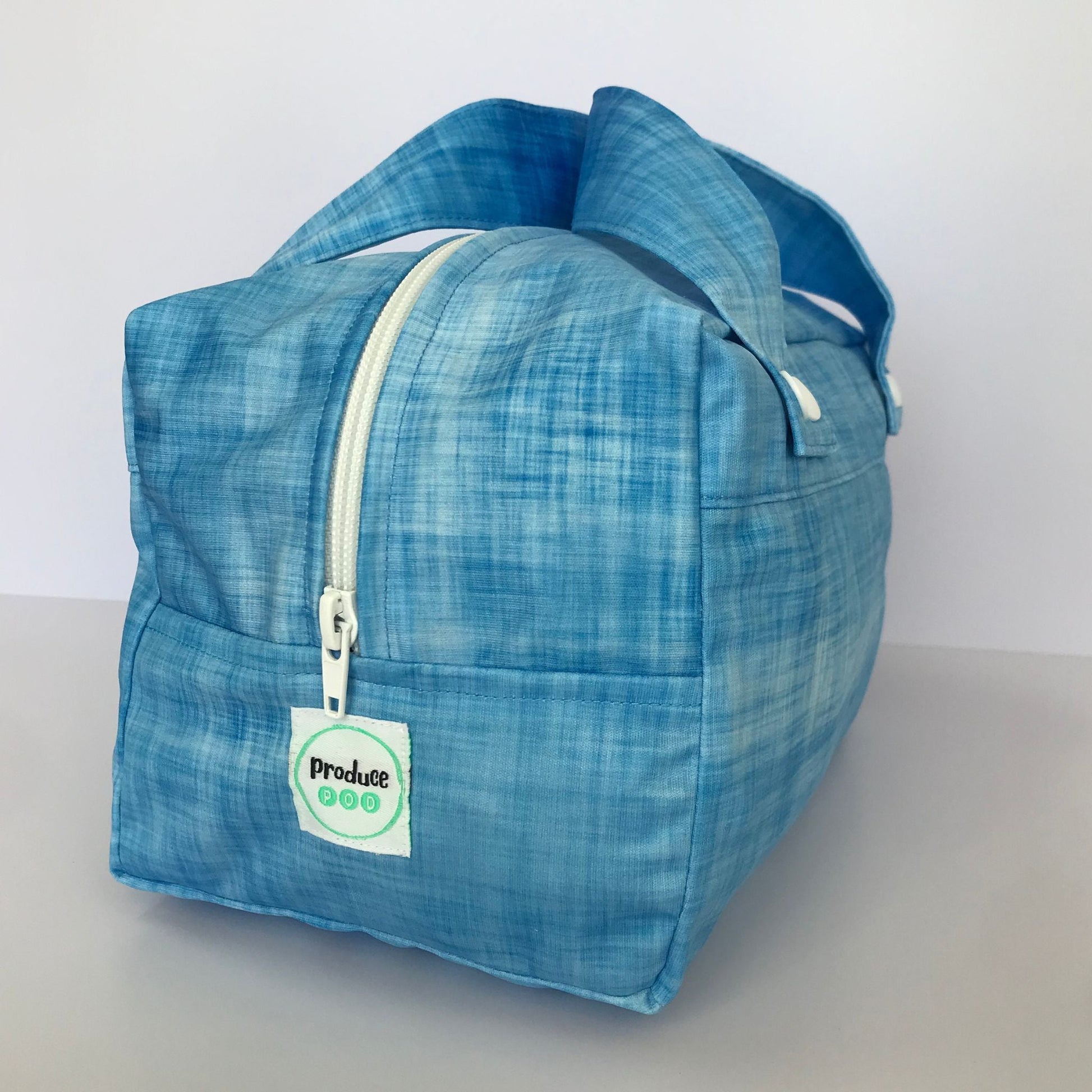 Detailed close up view of the durable woven bag securely zipped on a kitchen benchtop in blueberry.