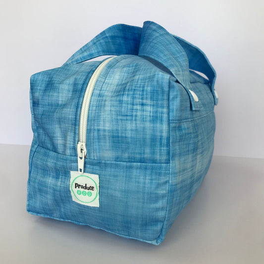 Detailed close up view of the durable woven bag securely zipped on a kitchen benchtop in blueberry.