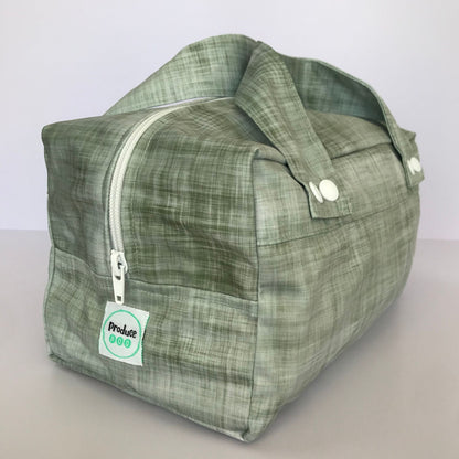 Detailed close up view of the durable woven bag securely zipped on a kitchen benchtop in gum leaf.