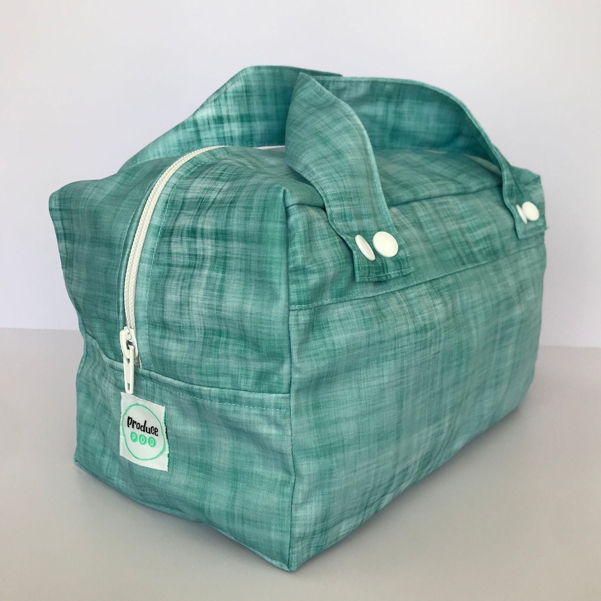 Detailed close up view of the durable woven bag securely zipped on a kitchen benchtop in ocean.