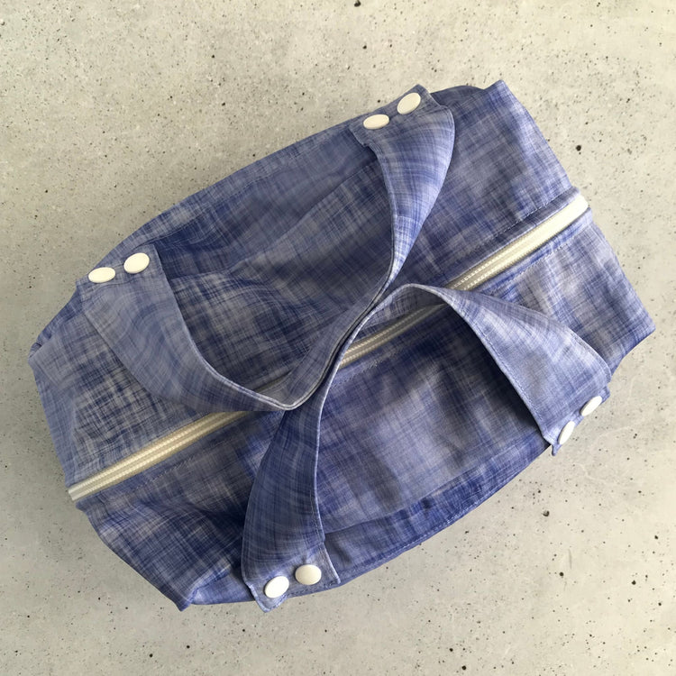 Micro view of the lightweight, highly breathable fabric weave engineered to regulate humidity and prevent mould in a refrigerator. Shown in plum.