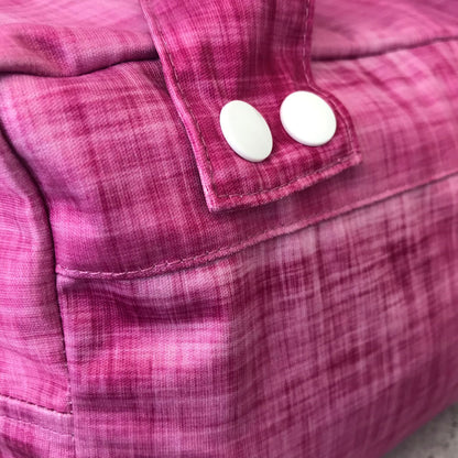 Micro view of the lightweight, highly breathable fabric weave engineered to regulate humidity and prevent mould in a refrigerator. Shown in rhubarb.