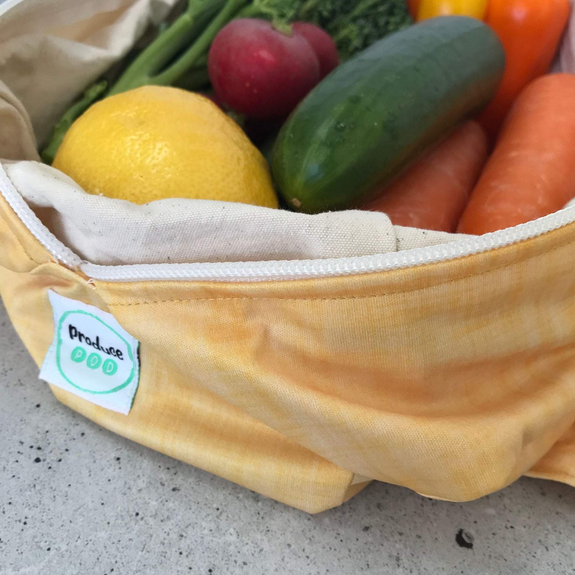 Macro view of the lightweight, highly breathable fabric weave engineered to regulate humidity and prevent mould in a refrigerator. Lemon variant.