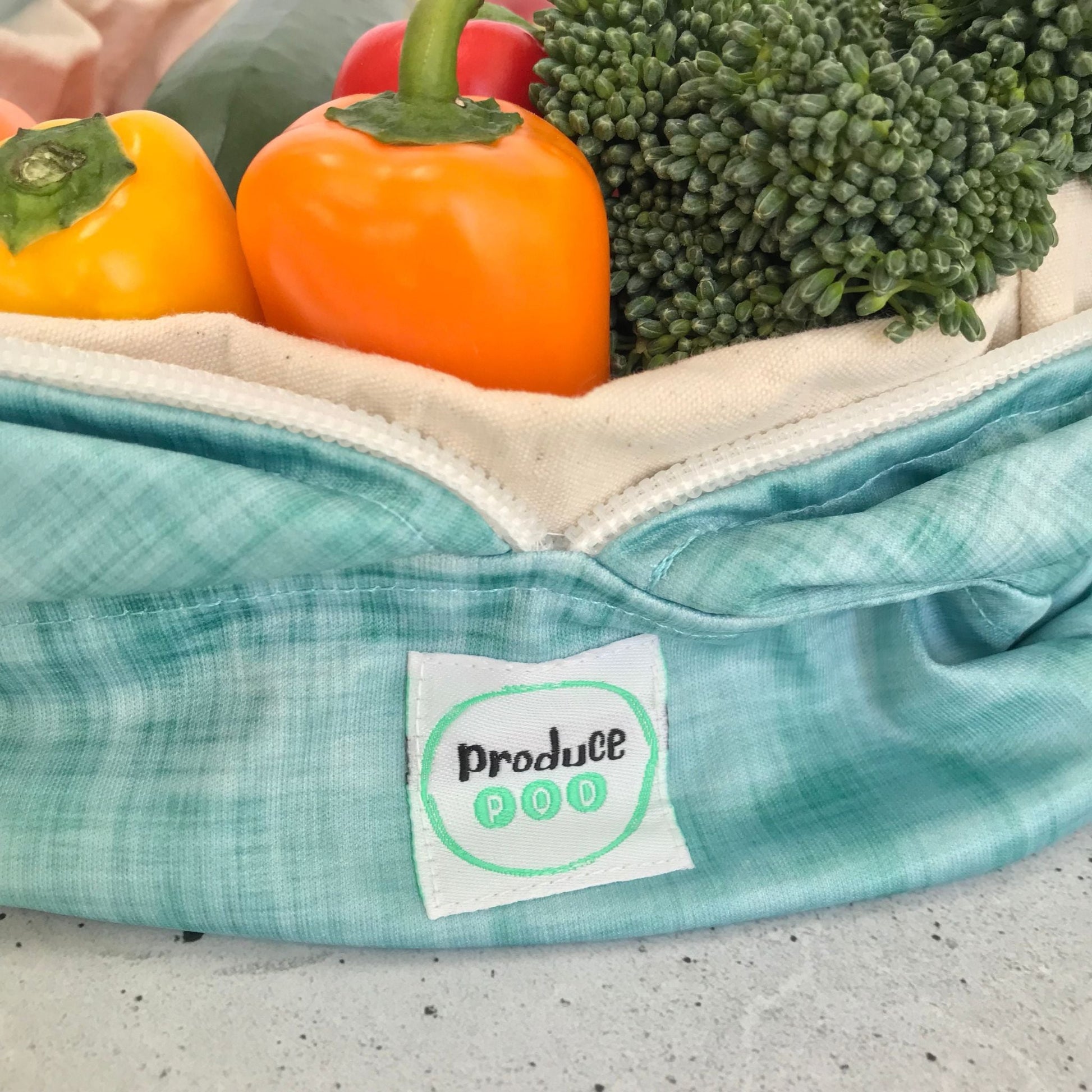 Macro view of the lightweight, highly breathable fabric weave engineered to regulate humidity and prevent mould in a refrigerator. Ocean variant.