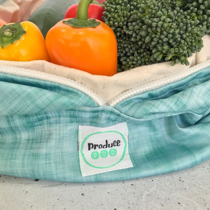 Macro view of the lightweight, highly breathable fabric weave engineered to regulate humidity and prevent mould in a refrigerator. Ocean variant.
