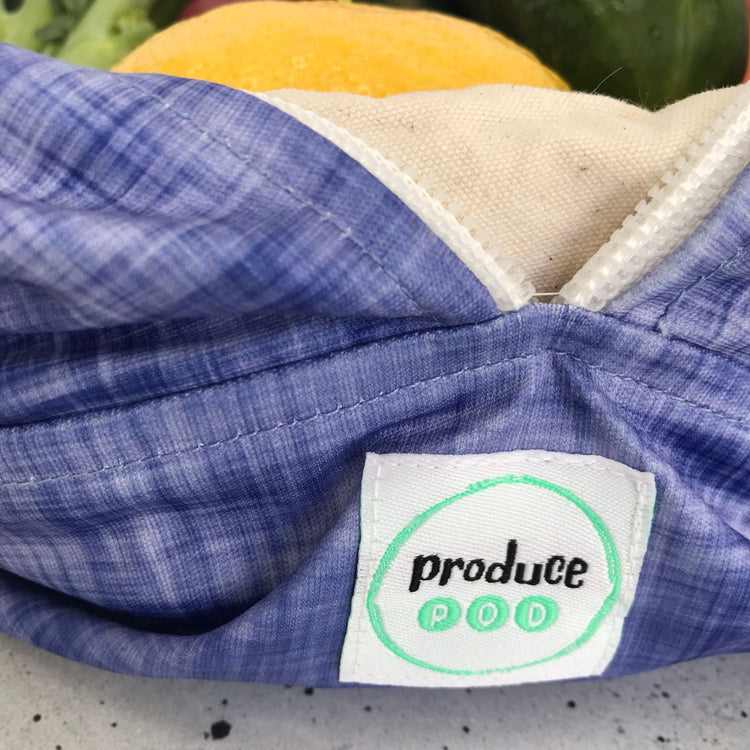 Macro view of the lightweight, highly breathable fabric weave engineered to regulate humidity and prevent mould in a refrigerator. Plum variant.