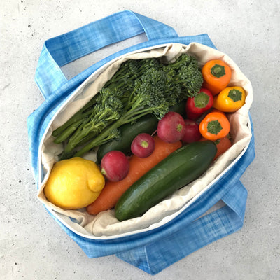 Single Produce Pod reusable veggie storage bag featuring a custom Blueberry print standing open filled with fresh veg and fruit on a white background, available in Australia.