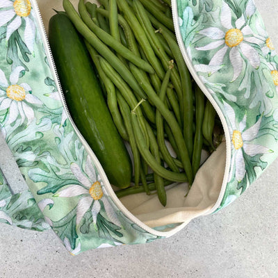 Single Produce Pod reusable veggie storage bag featuring a custom Flannel flower print standing open filled with fresh veg and fruit on a white background, available in Australia.