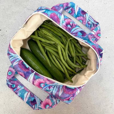 Single Produce Pod reusable veggie storage bag featuring a custom Gum blossom print standing open filled with fresh veg and fruit on a white background, available in Australia.