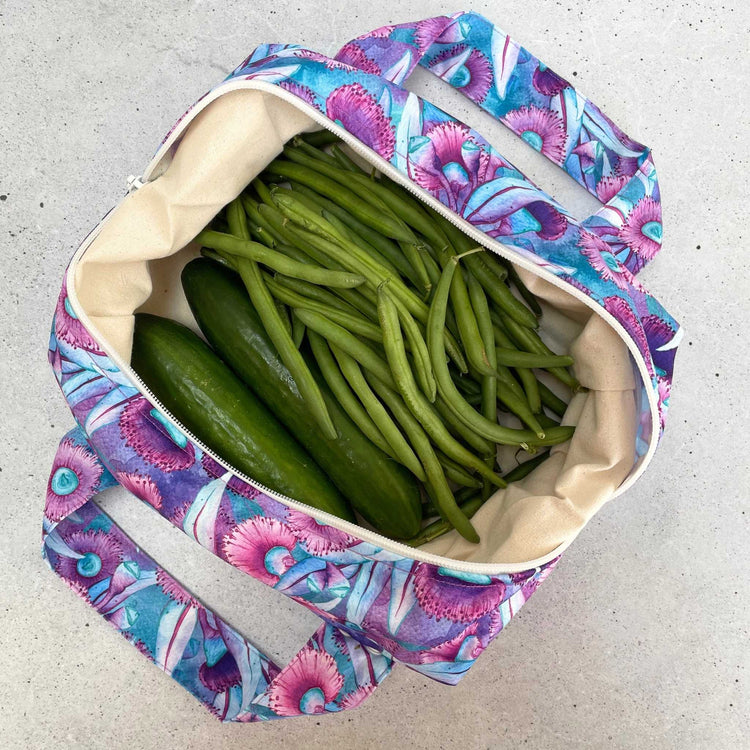 Single Produce Pod reusable veggie storage bag featuring a custom Gum blossom print standing open filled with fresh veg and fruit on a white background, available in Australia.