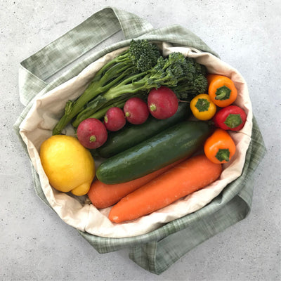 Single Produce Pod reusable veggie storage bag featuring a custom Gum leaf print standing open filled with fresh veg and fruit on a white background, available in Australia.