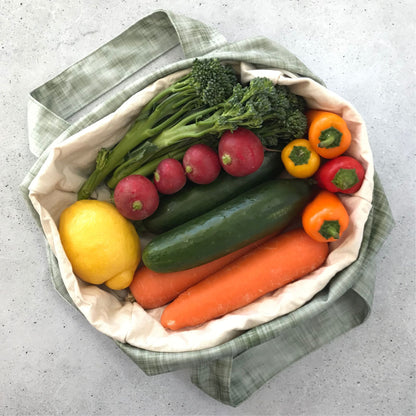 Single Produce Pod reusable veggie storage bag featuring a custom Gum leaf print standing open filled with fresh veg and fruit on a white background, available in Australia.