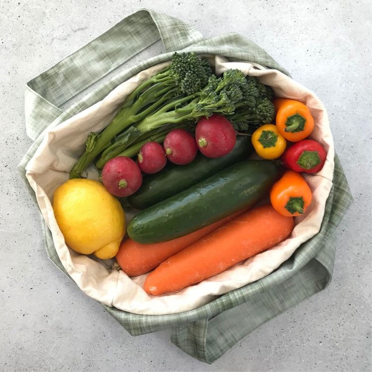 Single Produce Pod reusable veggie storage bag featuring a custom Gum leaf print standing open filled with fresh veg and fruit on a white background, available in Australia.
