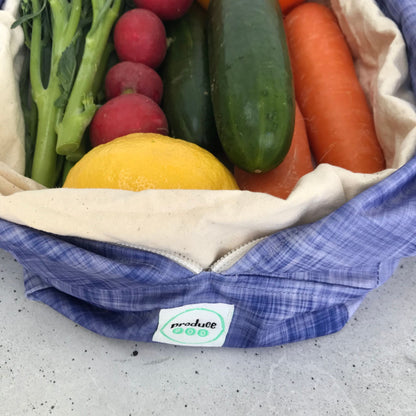 Single Produce Pod reusable veggie storage bag featuring a custom Plum print standing open filled with fresh veg and fruit closeup with zucchin, carrot, radish and broccolini.