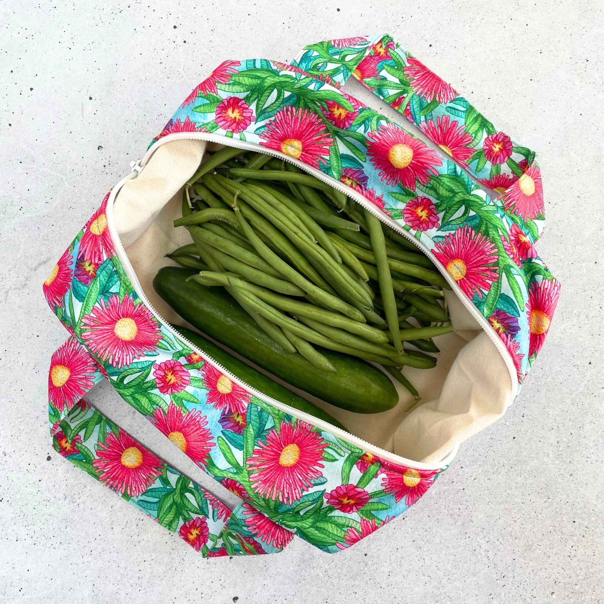 Single Produce Pod reusable veggie storage bag featuring a custom Sea fig print standing open filled with fresh veg and fruit on a white background, available in Australia.