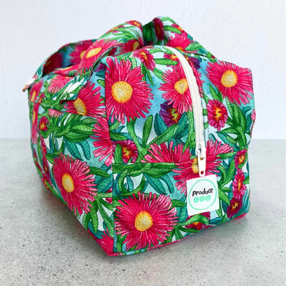 Side view of single Produce Pod reusable veggie storage bag featuring a custom Sea fig print zipped on a countertop.