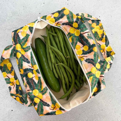 Single Produce Pod reusable veggie storage bag featuring a custom Wattle print standing open filled with fresh veg and fruit on a white background, available in Australia.