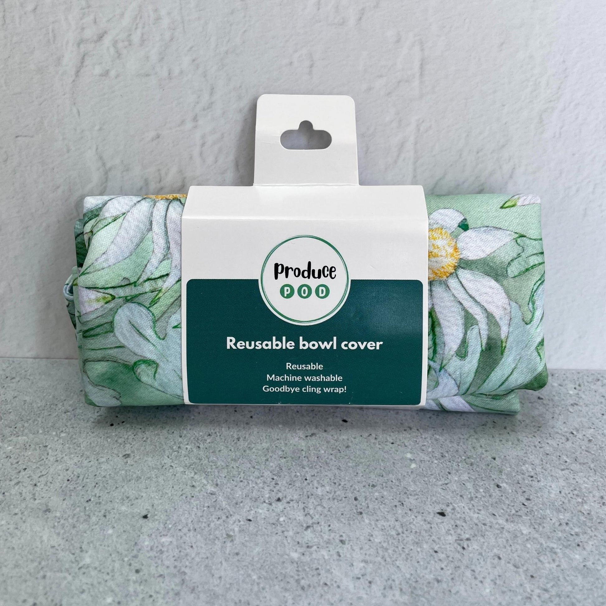 A Produce Pod reusable bowl cover in a Flannel Flower print folded in packaging.
