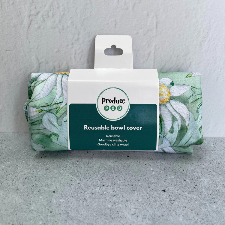 A Produce Pod reusable bowl cover in a Flannel Flower print folded in packaging.