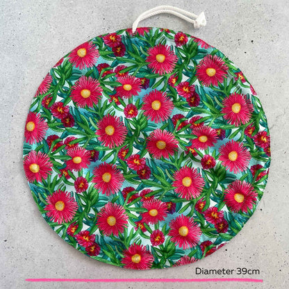An extra large thirty nine centimeter Produce Pod reusable bowl cover in a Sea fig print laid out on a surface top view.