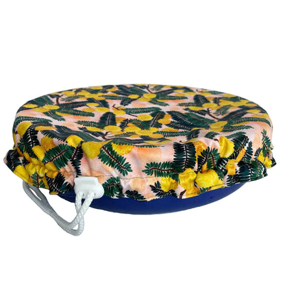 Produce Pod reusable bowl cover in a Wattle print fitted snugly over a serving dish, available in Australia.
