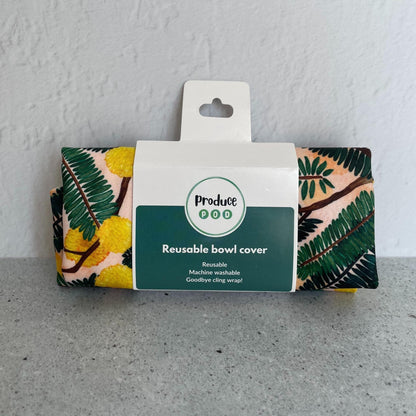 A Produce Pod reusable bowl cover in a Wattle print folded in packaging.