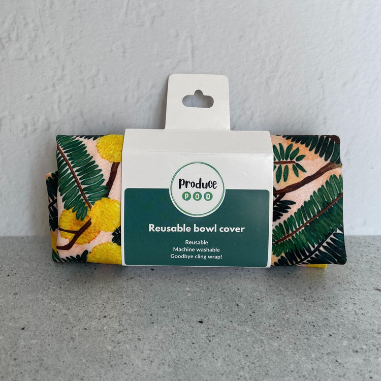 A Produce Pod reusable bowl cover in a Wattle print folded in packaging.
