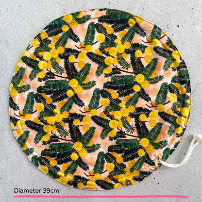 Produce Pod reusable bowl cover in a Wattle print laid out on a surface top view.