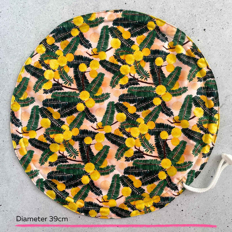 Produce Pod reusable bowl cover in a Wattle print laid out on a surface top view.
