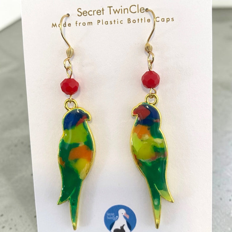 A pair of handmade upcycled plastic bird dangle statement earrings featuring artisan color marbling, made in Australia. Rainbow Lorikeet variant.