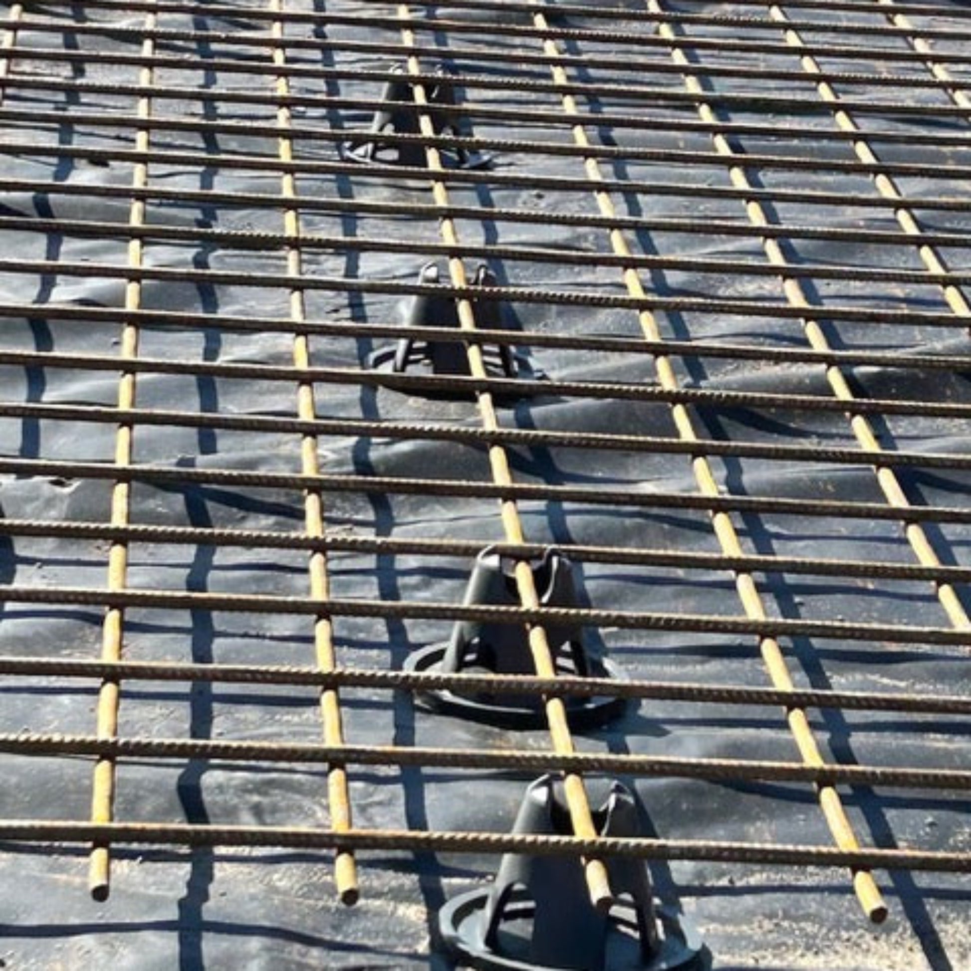 Sustainable concrete rebar chairs made from 100% recycled Dulux powder coating waste, compliant with AS2425 structural reinforcement standards in position ready for concrete.